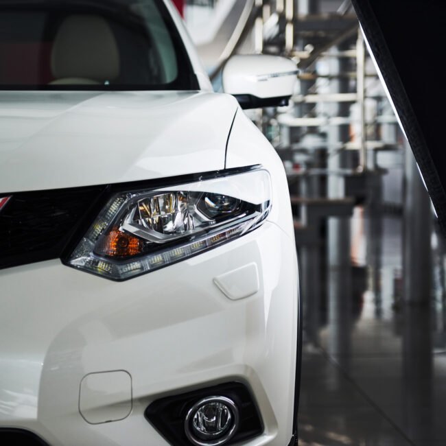 The headlights and the hood of a new luxury car.